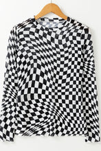 Front view of ChicGrid women’s checkered mock neck long sleeve blouse in black, on a wooden clothes hanger.