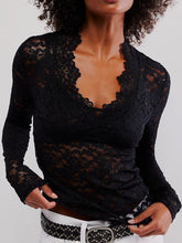Close-up of black floral lace on Laceaura Top with flared sleeve cuff.