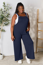 Model wearing Cyrella Muse Wide-Leg Overalls in timeless Dark Navy, front view.