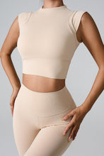 a model posing the front view of the Tan color Mock Neck Active Tank