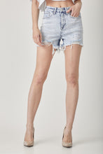 Lifestyle shot of RISEN Raw Hem Distressed Shorts styled with a bikini top and flip-flops, perfect for beach boardwalk strolls.