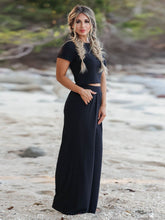 Model posing in Auralenne Coastal Lounge Set in black on the beach