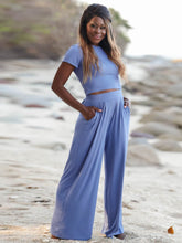 Auralenne Coastal Lounge Set in light blue front view styled on the beach, hands in pockets