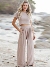 Model posing in Auralenne Coastal Lounge Set in tan on the beach
