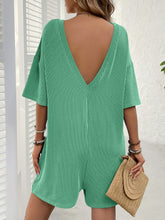 Back view of green Breezy Bold Romper showing plunging V-back.