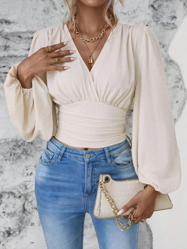 Model styled in beige Balloonique™ Blouse with accessories for a complete look.
