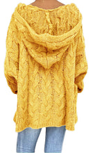Model showcasing the back of a banana yellow color Tessyra Cable-Knit Hooded Sweater paired with jewelry, and blue denim jeans.