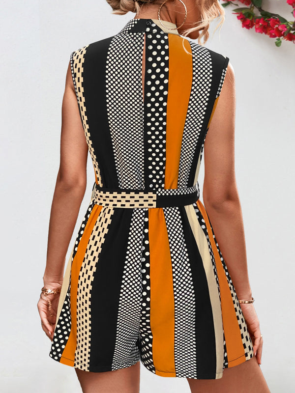 Back view of model in GeoChic Harmony Romper, showcasing keyhole button closure, sleeveless cut, and subtle fabric movement—styled with minimal clutch and relaxed waves.
