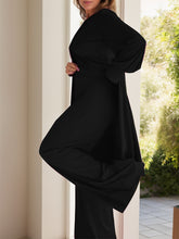 Side view of Kurevelle Slit Round Neck Top and Pants Twosome in black showing wide leg and slit top