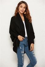 Woman hiking a forest trail in Black SeraphinaWing Cardigan, styled over a tank and leggings.