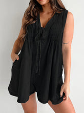 Sleek black romper styled with bold red lipstick, boots, and a chain bag—elevated, edgy, and powerful.