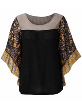 Front view of the BlossomEase Blouse in black to show floral sleeves and ruffle trim.