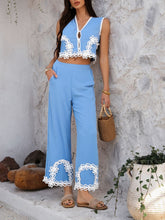Woman in Blue Xyvello set leaning on marble wall by plant front view with hand in pocket