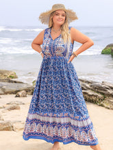 Feminine standing resort beach side in Bohemysa Royal Blue Maxi Dress paired with a straw hat.