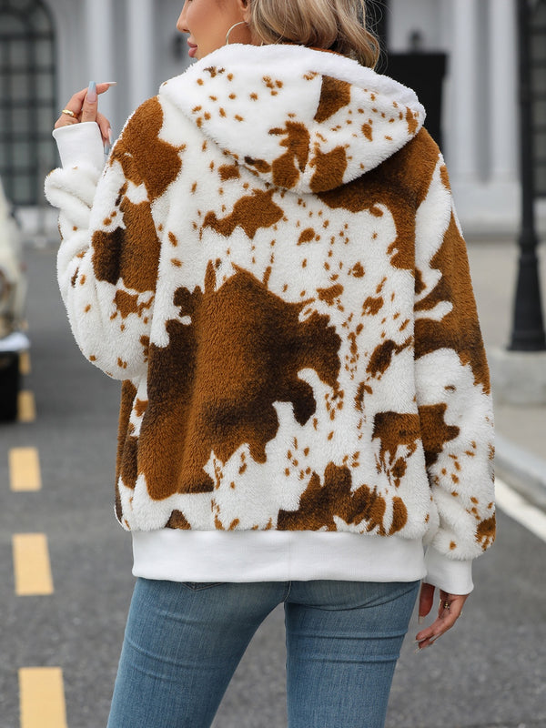 a model showcasing the back of a brown Western Patch design Fuzzy Drawstring Zip Hooded Jacket paired with jeans and jewelry 