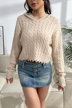 A model wearing a sand color Urban Cable Knit Sweater paired with jewelry and a light blue denim skirt.