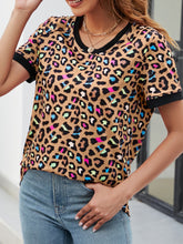 Detailed view of camel leopard print fabric, showcasing warm camel base with rich, contrasting animal print in earthy tones.
