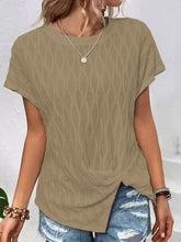 A woman shopping in London wearing the camel Ruched Wavy Pattern Round Neck Short Sleeve T-Shirt paired with distressed denim shorts, jewelry, and heels.