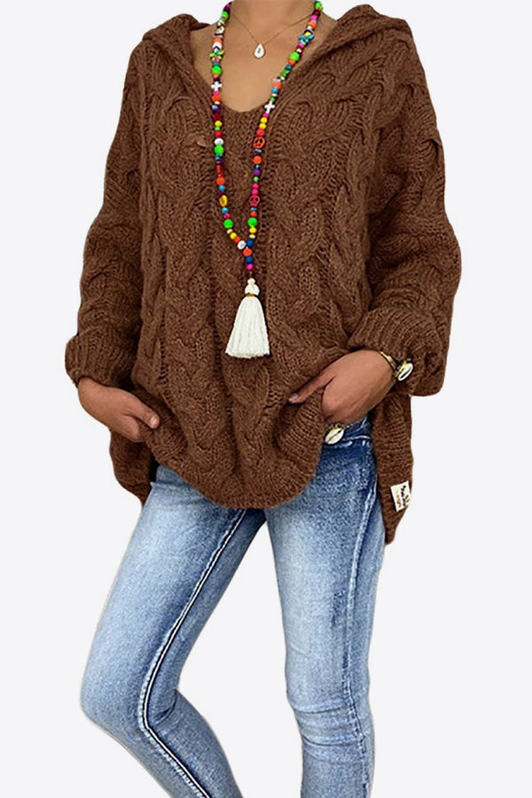 Model wearing the Chestnut color Tessyra Cable-Knit Hooded Sweater paired with jewelry and blue denim jeans.