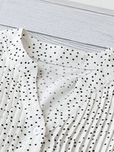 Close-up of neckline slit and buttons on white EverDot Flutter Top.