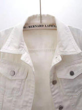 A close up photo of the mid sleeve detail, pockets, and quality fabric of a white Full Size Cropped Denim Plus Size Jacket.