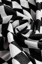 Close-up of black ChicGrid blouse checkered fabric texture, highlighting quality construction and soft stretch material.