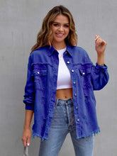 A model wearing the royal blue color CloudKitten Distressed Drop Shoulder Denim Jacket paired with a white crop top, blue jeans, Jewelry, and handbag.