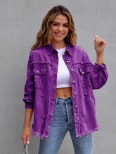 A model wearing the violet color CloudKitten Distressed Drop Shoulder Denim Jacket paired with a white crop top, blue jeans, Jewelry, and handbag.