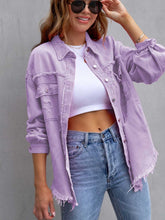 A model wearing the lavender color CloudKitten Distressed Drop Shoulder Denim Jacket paired with a white crop top, blue jeans, Jewelry, and handbag.