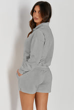 Woman back view in cloudy blue Half-Button Sweatshirt and Shorts Active Set.