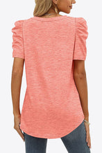 Back view of coral puff sleeve tee with subtle sleeve gathers and clean, slightly tapered silhouette.