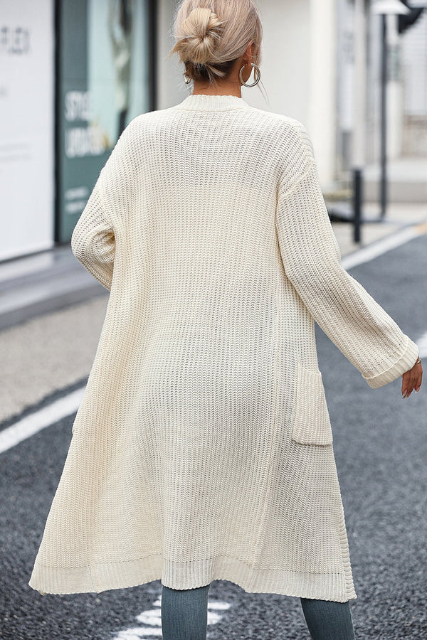 Back view of model in cream Thalora Cascade Cardigan, below-knee length