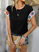 Model styled in black CrochetCharm Top with casual shorts, heels, a brown straw purse, and accessories for a complete look.