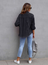 Back view of model in a black CloudKitten Distressed Drop Shoulder Denim Jacket, with understated distressing and a modern, relaxed fit.