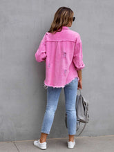 Back view of model wearing a hot pink CloudKitten Distressed Drop Shoulder Denim Jacket, featuring light distressing and a relaxed, drop shoulder fit.