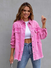 A model wearing the hot pink color CloudKitten Distressed Drop Shoulder Denim Jacket paired with a white crop top, blue jeans, Jewelry, and handbag.