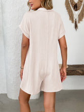 Back view of eggshell romper on model with relaxed hairstyle.