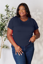 Model smiling in vibrant dark blue solid short sleeve t-shirt