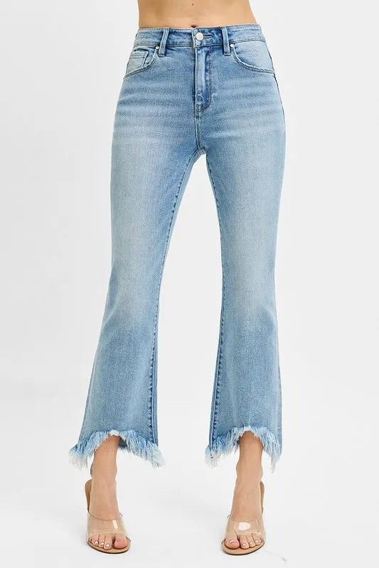 Plus size high rise crop bootcut jeans with fray hem, front view.