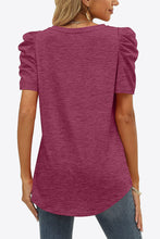 Rear shot of fuchsia puff sleeve tee showing bright, bold color with soft puff sleeves and clean back design.