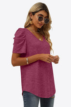Woman in fuchsia V-Neck Puff Sleeve Tee paired with accessories for a laid-back casual look.