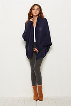 Woman modeling Dark Navy SeraphinaWing Cardigan, side profile with elegant sleeve fall.