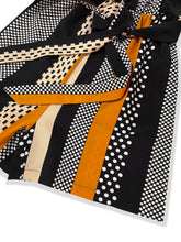 Detailed flat lay of romper’s waist tie knot and precision stitching at the waistline, emphasizing tailored quality, durability, and flattering cinched shape.