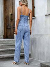 Back view of model in Gildoria™ Spaghetti Strap Denim Overalls, highlighting adjustable straps and functional back pockets.