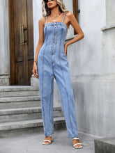 Model wearing Gildoria™ Spaghetti Strap Denim Overalls in light blue, front view showcasing exposed seams and half-button-up detail.
