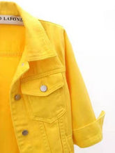 A close up photo of the mid sleeve detail, pocket, and quality fabric of a gold Full Size Cropped Denim Plus Size Jacket.