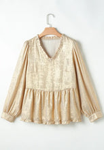 Back view of Glimmerelle™ Blouse in Gold, highlighting the ruffled peplum hem, on a hanger.