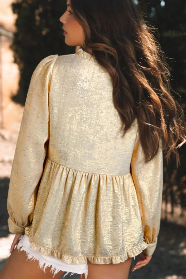 Back view of Glimmerelle™ Blouse in Gold, highlighting the ruffled peplum hem, accessorized with gold jewelry and sneakers.