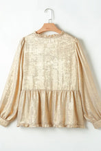 Close-up of Glimmerelle™ Blouse's V-neckline and shimmering fabric in Gold.