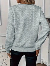 a model showcasing the back of a gray Sunset Coastal Bliss Texture Half Zip Long Sleeve Sweatshirt paired with dark blue jeans and jewelry